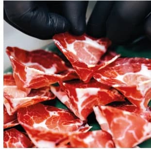 Slices of capocollo cut by hand